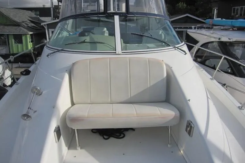 Slide: The Image of 2006 Carver 36 Mariner boat with white seating on deck, docked at marina. - 35