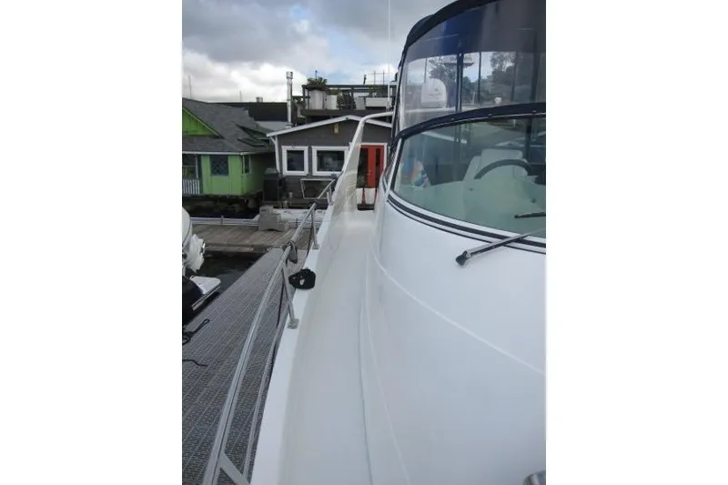 Slide: The Image of 2006 Carver 36 Mariner yacht docked, showcasing sleek design and spacious deck. - 37
