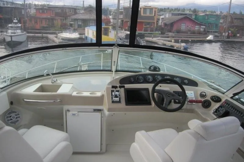 Slide: The Image of Interior view of 2006 Carver 36 Mariner yacht cockpit with steering wheel and controls. - 38