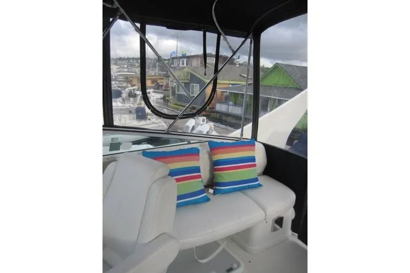 Slide: The Image of 2006 Carver 36 Mariner interior with colorful striped cushions and marina view. - 41