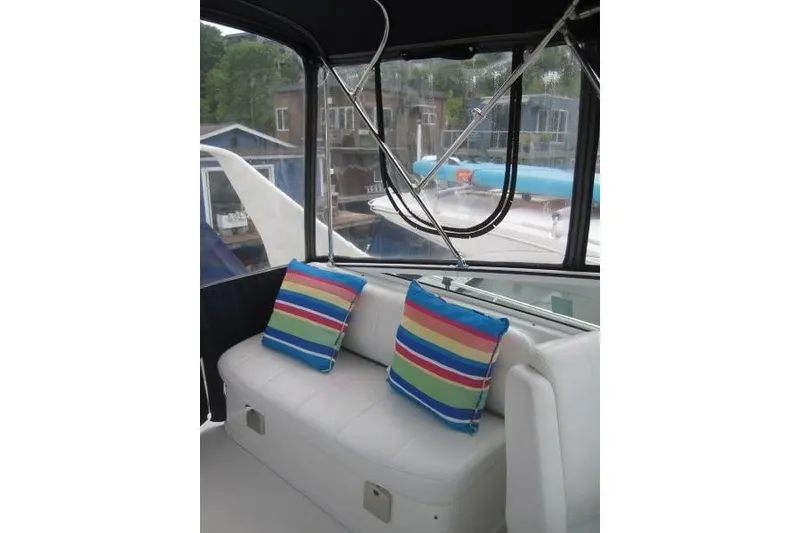 Slide: The Image of Interior of 2006 Carver 36 Mariner with striped cushions on white seating. - 44
