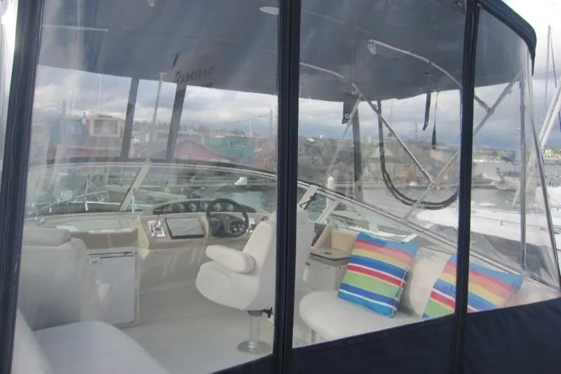 Slide: The Image of 2006 Carver 36 Mariner yacht interior with helm, seating, and colorful cushions. - 46