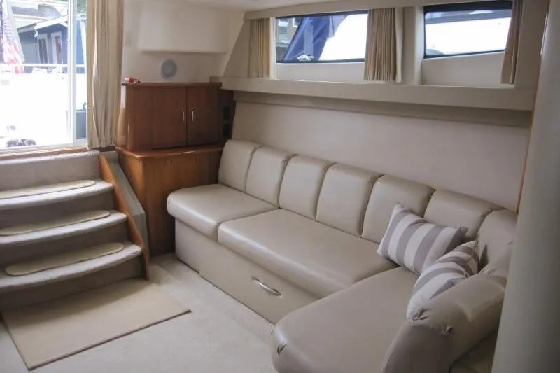 Slide: The Image of Interior of 2006 Carver 36 Mariner yacht with beige seating and striped pillows. - 6