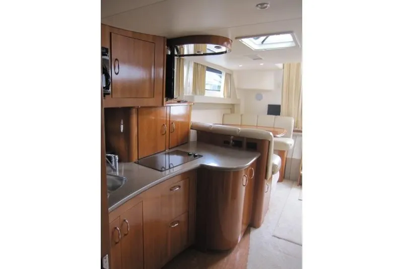 Slide: The Image of Interior of 2006 Carver 36 Mariner yacht with modern kitchen and seating area. - 7