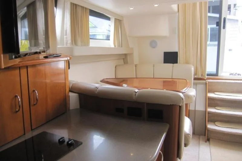 Slide: The Image of Interior of 2006 Carver 36 Mariner yacht with elegant seating and dining area. - 8