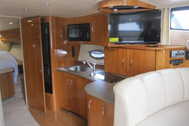 Slide: The Image of Interior of 2006 Carver 36 Mariner yacht with kitchen, TV, and seating area. - 9