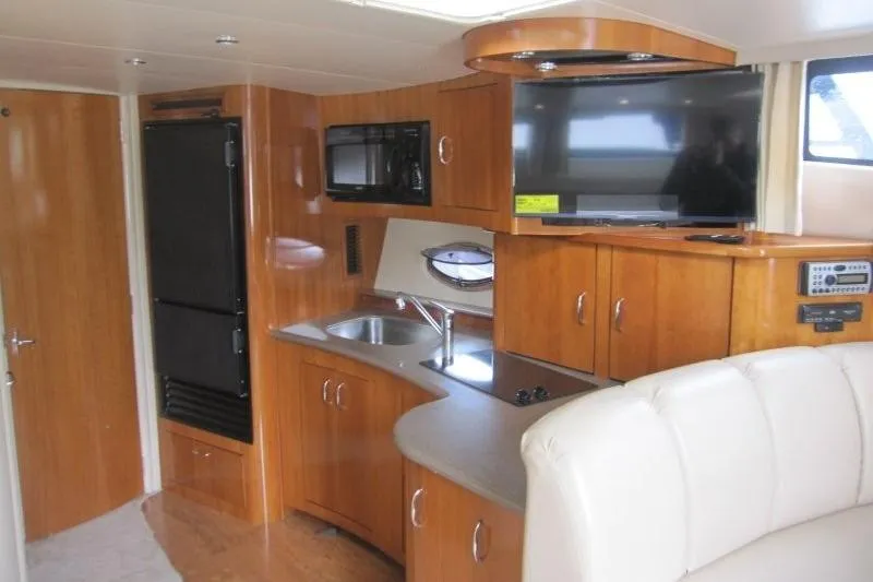 Slide: The Image of Interior of 2006 Carver 36 Mariner yacht with kitchenette and TV. - 10