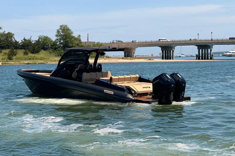 Slide: The Image of 2023 Skipper-BSK 42NC boat cruising near a bridge on a sunny day. - 3