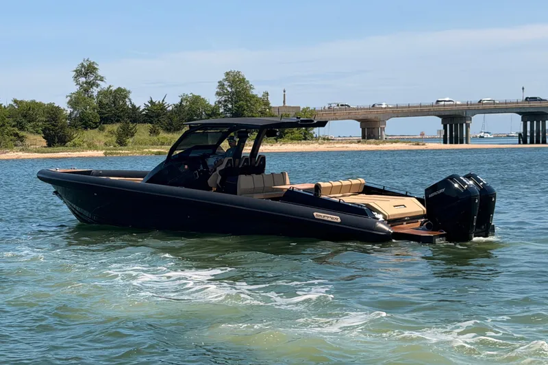 Slide: The Image of 2023 Skipper-BSK 42NC boat cruising near a bridge on a sunny day. - 4