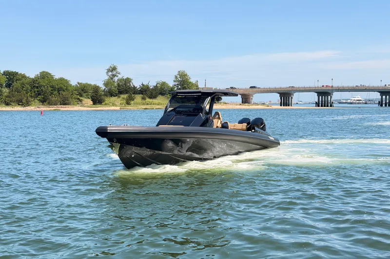 Slide: The Image of 2023 Skipper-BSK 42NC boat cruising on a sunny day near a bridge. - 7