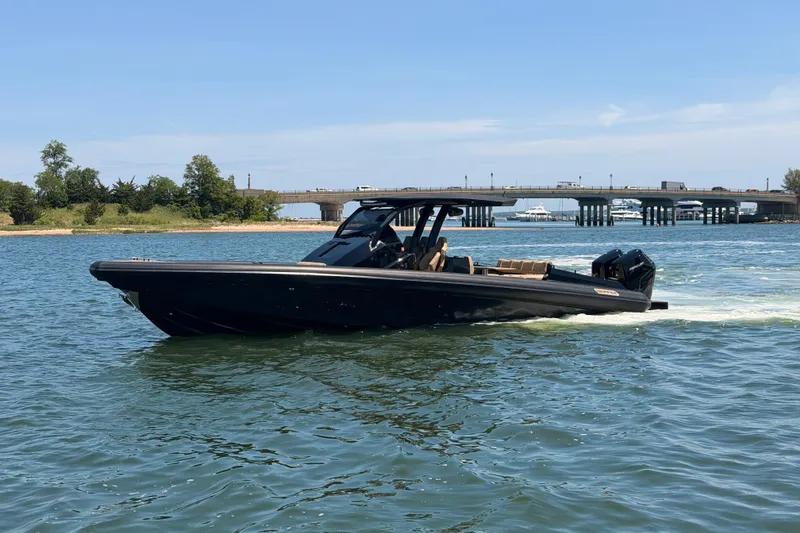 Slide: The Image of 2023 Skipper-BSK 42NC boat cruising on a sunny day near a bridge. - 8