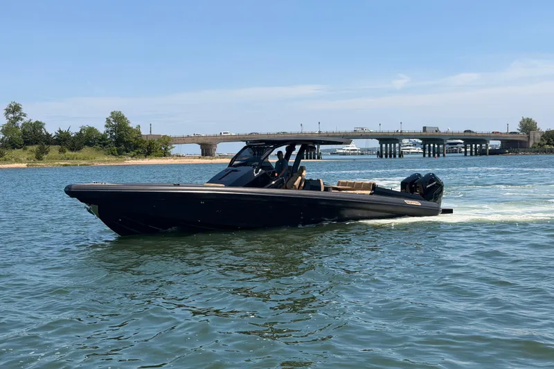 Slide: The Image of 2023 Skipper-BSK 42NC boat cruising on a sunny day near a bridge. - 9