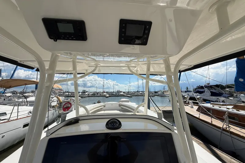 Slide: The Image of 2019 Regulator 34SS boat interior view at marina with clear sky and docked yachts. - 13
