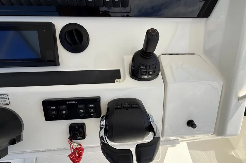 Slide: The Image of Control panel of a 2019 Regulator 34SS boat featuring Yamaha controls and joystick. - 14