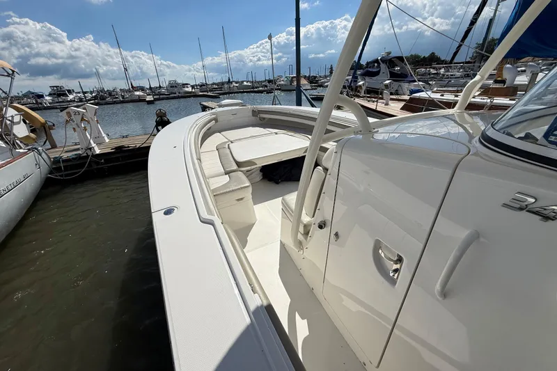 Slide: The Image of 2019 Regulator 34SS boat docked at marina under a partly cloudy sky. - 16