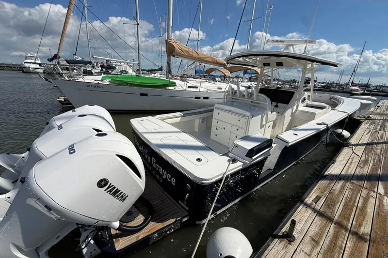 Slide: The Image of 2019 Regulator 34SS boat docked with Yamaha engines, surrounded by sailboats. - 5