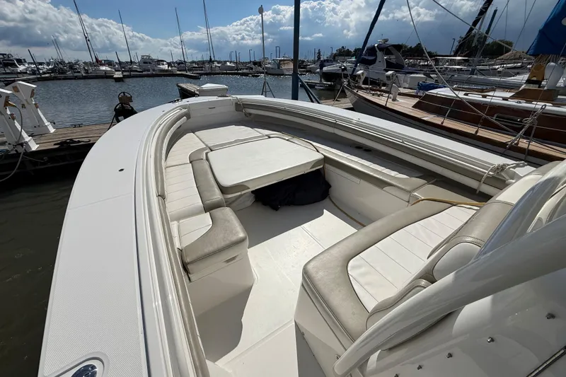 Slide: The Image of 2019 Regulator 34SS boat interior with spacious seating at a marina. - 17