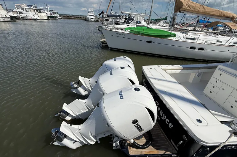 Slide: The Image of 2019 Regulator 34SS boat with triple Yamaha outboard engines docked at a marina. - 6