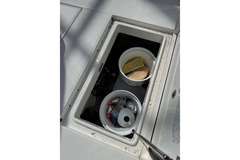 Slide: The Image of Storage compartment on a 2019 Regulator 34SS boat with cleaning supplies. - 21