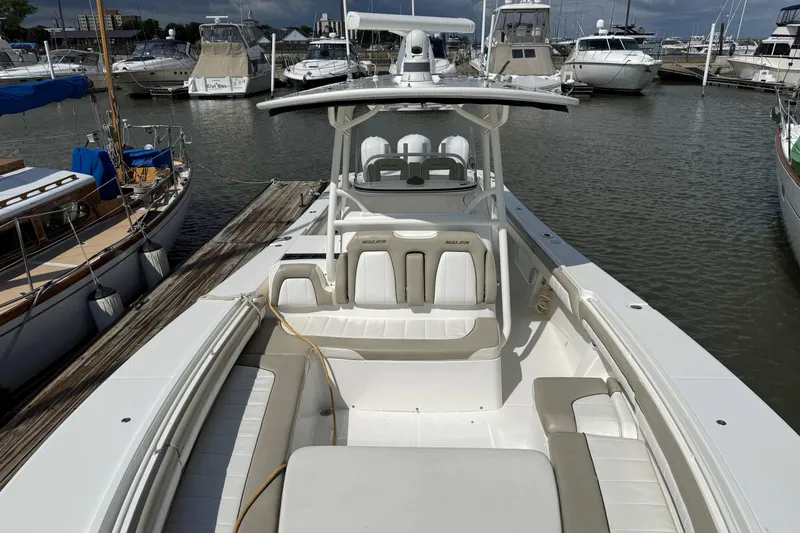 Slide: The Image of 2019 Regulator 34SS boat docked at marina, surrounded by other vessels. - 18