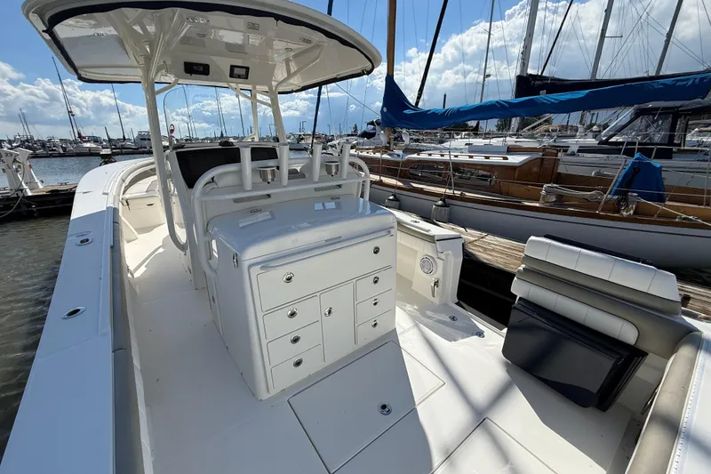 Slide: The Image of 2019 Regulator 34SS boat interior at marina, featuring helm and seating area. - 10