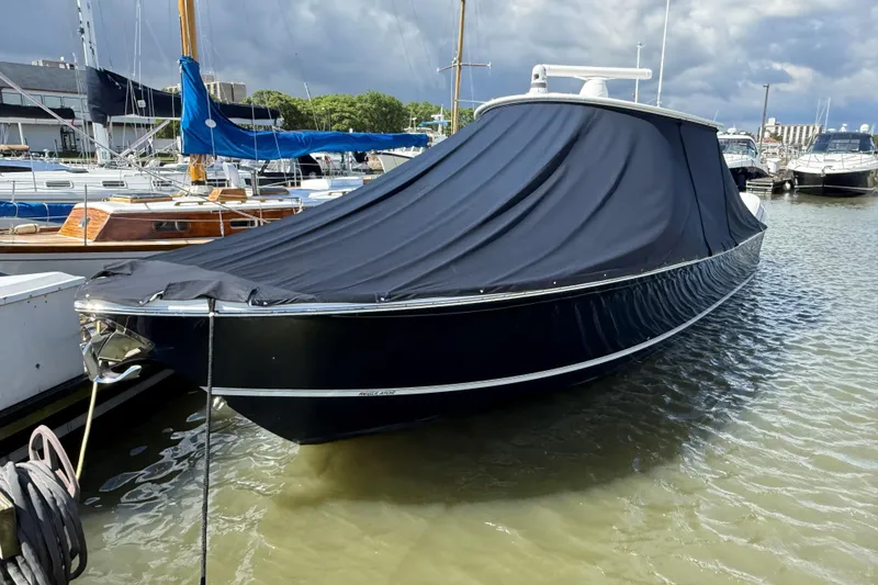 Slide: The Image of 2019 Regulator 34SS boat docked with protective cover in a marina. - 22