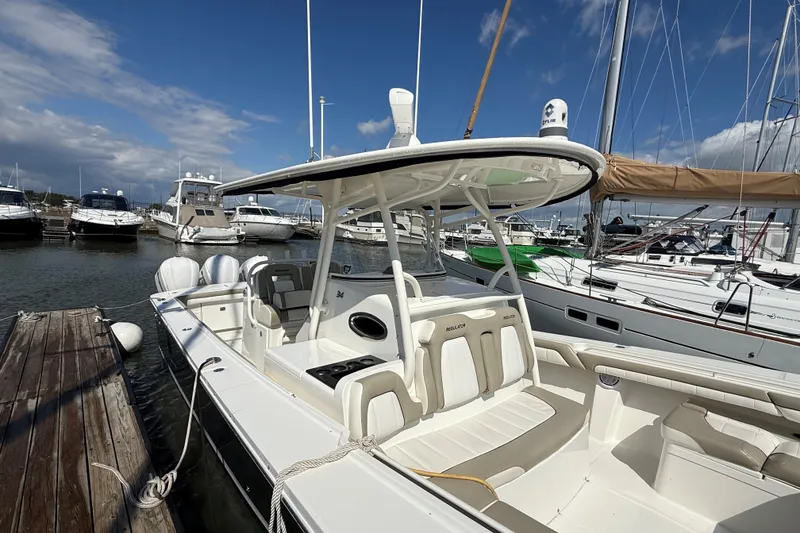 Slide: The Image of 2019 Regulator 34SS boat docked at marina with clear blue sky. - 4