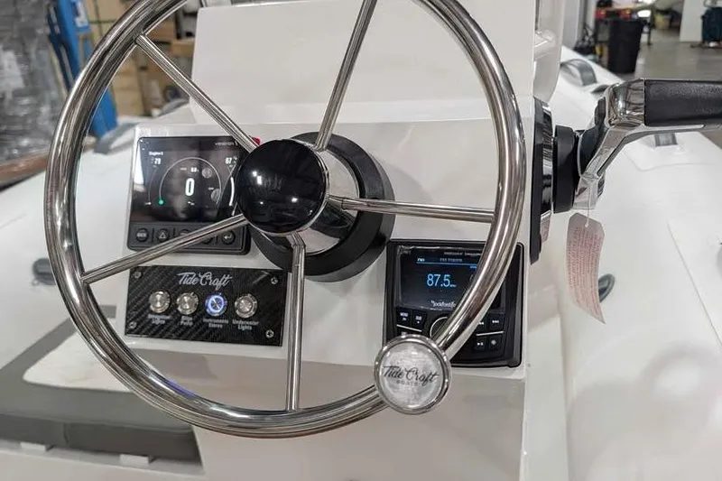 Slide: The Image of Steering console of 2027 Tide Craft San Juan 11 boat with modern controls and displays. - 11