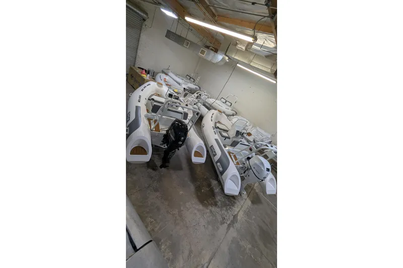 Slide: The Image of Warehouse with multiple 2027 Tide Craft San Juan 11 boats in storage. - 15