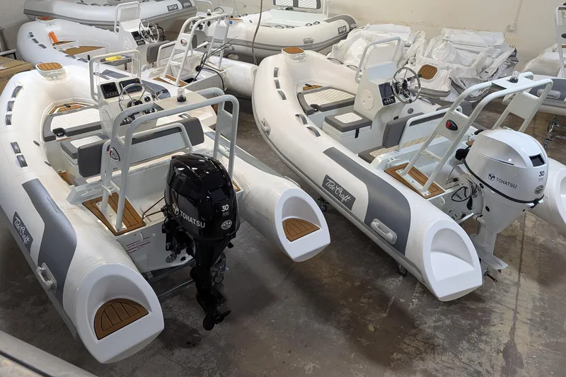 Slide: The Image of 2027 Tide Craft San Juan 11 inflatable boats with Tohatsu engines in a showroom. - 16