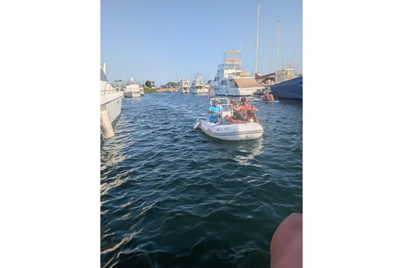 Slide: The Image of People enjoying a ride on a 2027 Tide Craft San Juan 11 boat in a marina. - 21