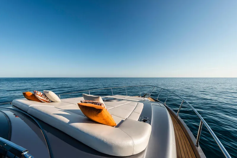 Slide: The Image of Luxurious 2023 Pershing 6X yacht deck with cushions, overlooking serene ocean view. - 6