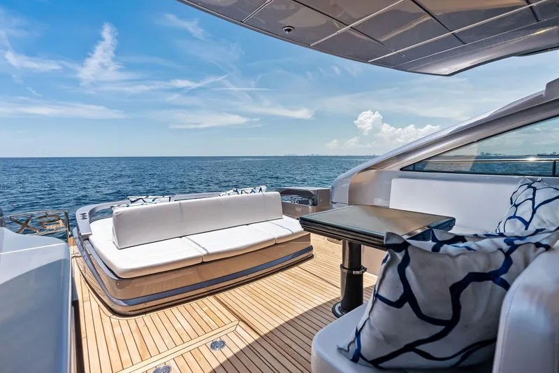 Slide: The Image of Luxurious 2023 Pershing 6X yacht deck with ocean view, featuring elegant seating and table. - 36
