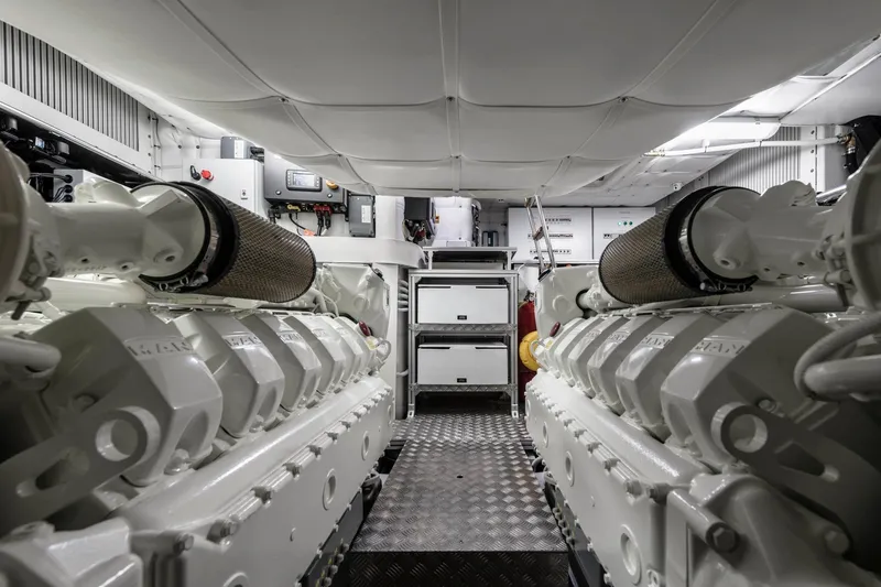 Slide: The Image of Engine room of 2023 Pershing 6X yacht, featuring advanced machinery and sleek design. - 21