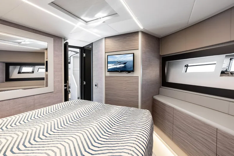 Slide: The Image of Luxurious interior of 2023 Pershing 6X yacht bedroom with modern design and window view. - 43
