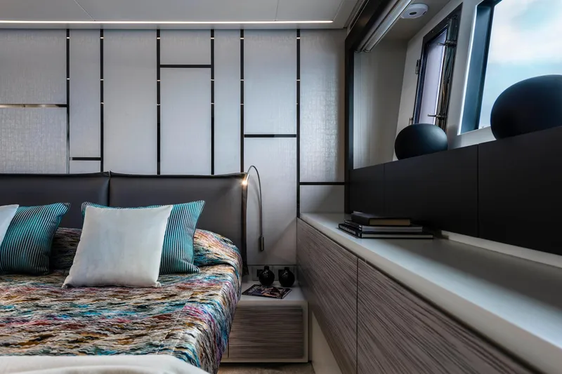 Slide: The Image of Luxurious 2023 Pershing 6X yacht bedroom with modern decor and stylish bedding. - 14