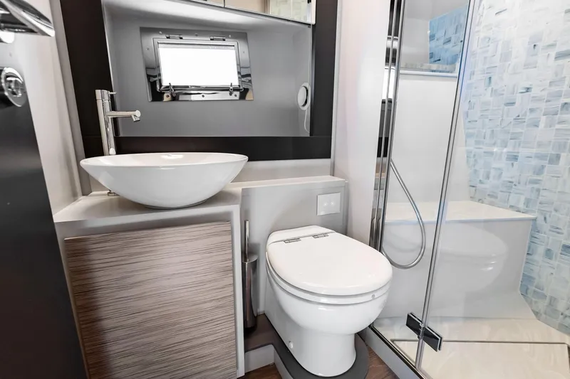 Slide: The Image of Modern bathroom in 2023 Pershing 6X yacht with sleek fixtures and glass shower. - 44