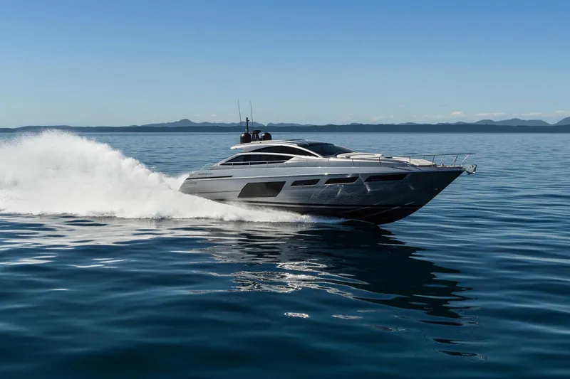 Slide: The Image of 2023 Pershing 6X yacht cruising on open water, showcasing sleek design and speed. - 2