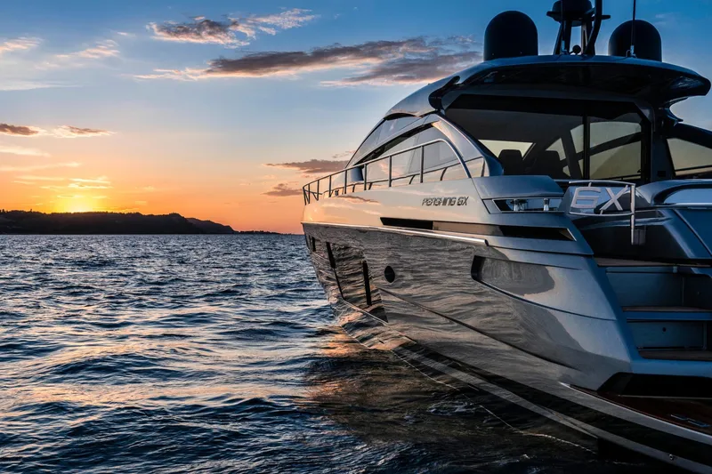 Slide: The Image of 2023 Pershing 6X yacht cruising at sunset on open water. - 9