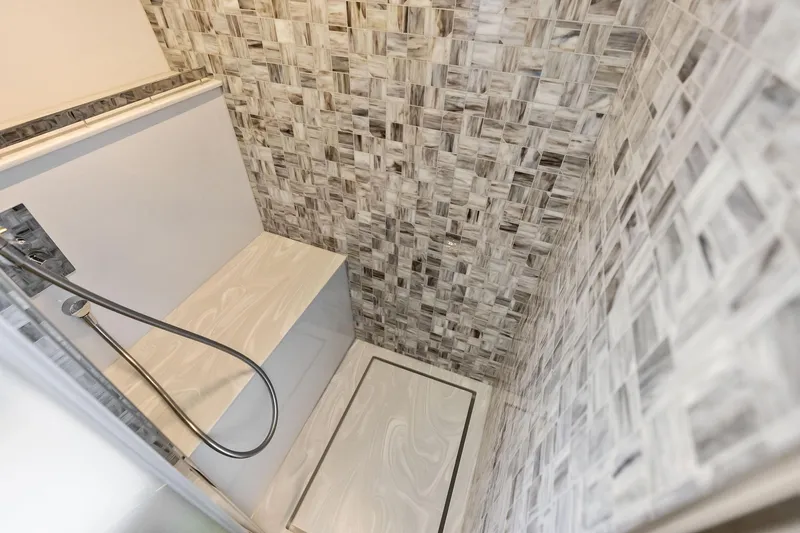 Slide: The Image of Luxurious shower area in 2023 Pershing 6X yacht with elegant tile design. - 39