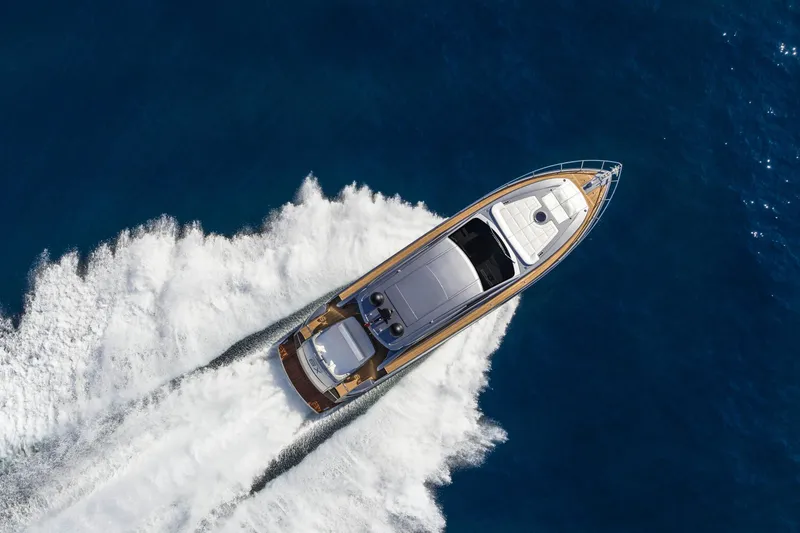 Slide: The Image of Aerial view of 2023 Pershing 6X yacht cruising on open blue sea. - 4