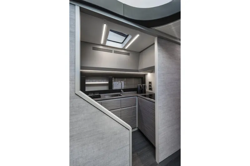 Slide: The Image of Modern kitchen interior of 2023 Pershing 6X yacht, featuring sleek cabinetry and lighting. - 11