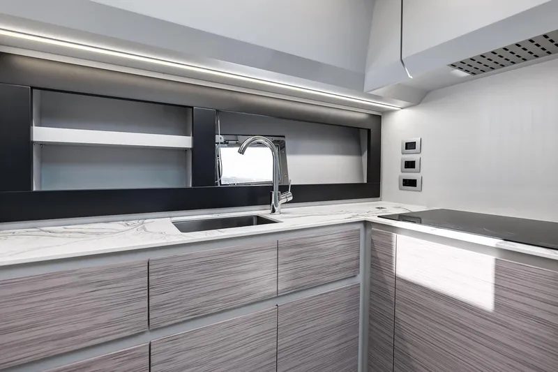 Slide: The Image of Modern kitchen interior of 2023 Pershing 6X yacht with sleek design and marble countertop. - 48
