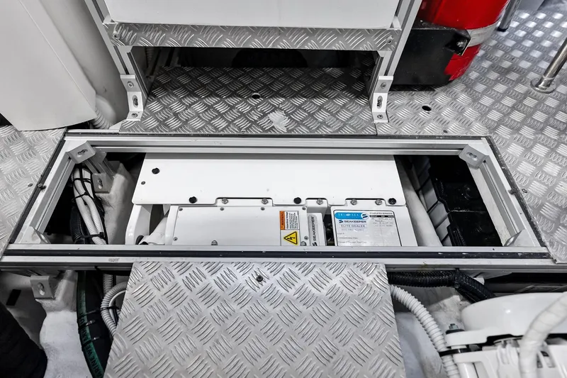 Slide: The Image of Engine compartment of 2023 Pershing 6X yacht with visible machinery and wiring. - 59