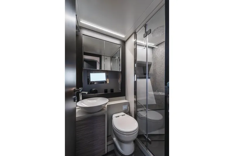 Slide: The Image of Modern bathroom interior in 2023 Pershing 6X yacht, featuring sleek fixtures and glass shower. - 19