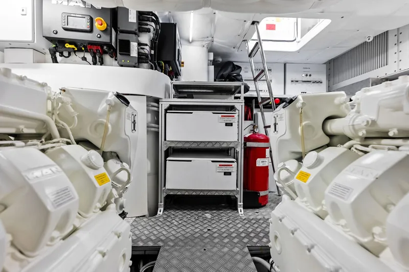 Slide: The Image of Engine room of 2023 Pershing 6X yacht, featuring advanced machinery and safety equipment. - 58