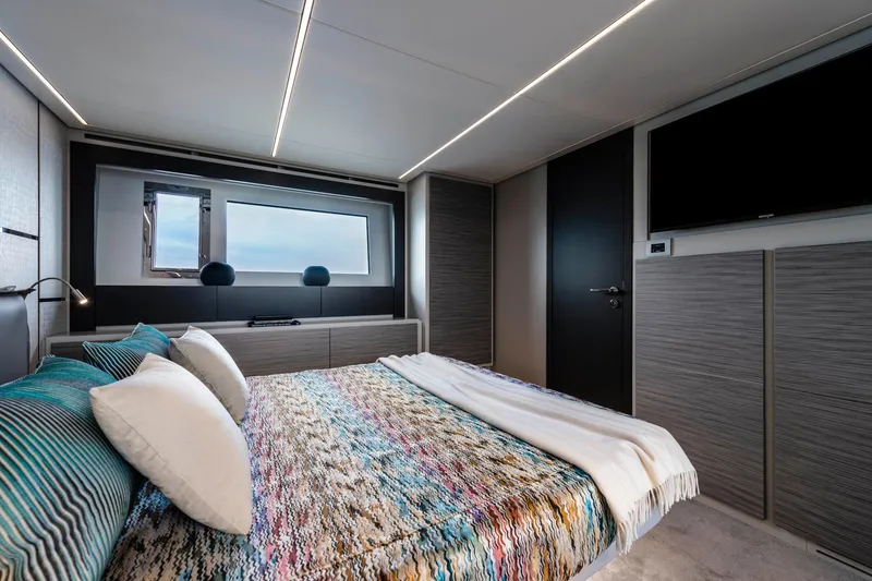 Slide: The Image of Luxurious bedroom interior of 2023 Pershing 6X yacht with modern design and large window. - 13