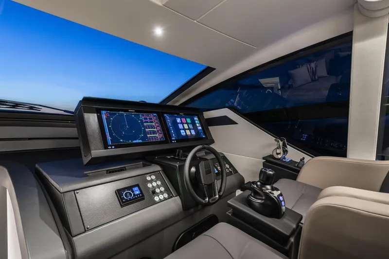Slide: The Image of 2023 Pershing 6X yacht cockpit with advanced navigation systems and luxurious seating. - 10