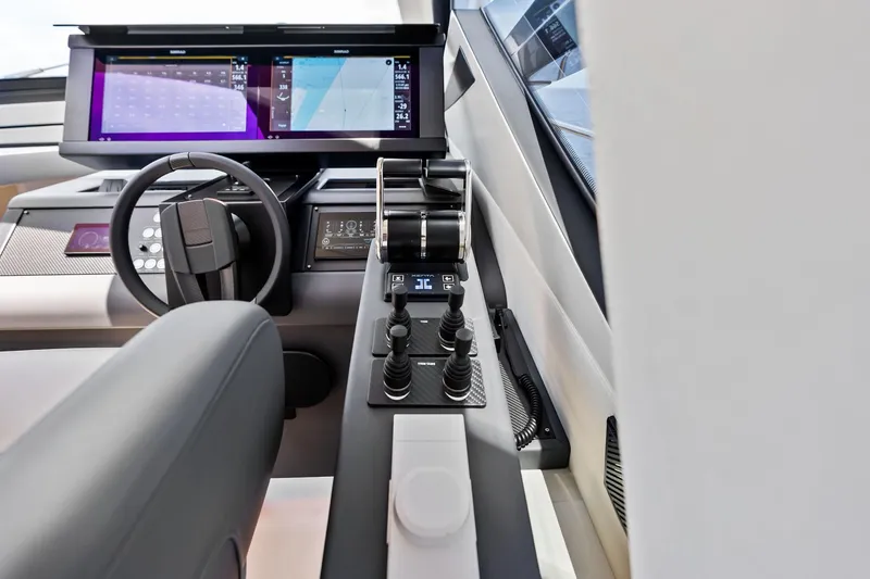 Slide: The Image of Cockpit of 2023 Pershing 6X yacht with modern controls and digital displays. - 26