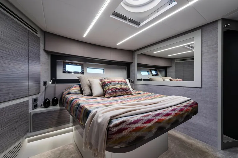 Slide: The Image of Luxurious 2023 Pershing 6X yacht bedroom with modern design and colorful bedding. - 18